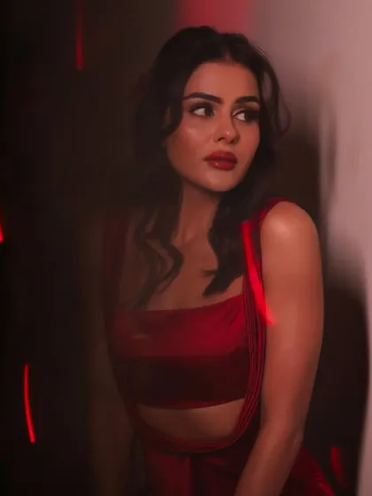 Stepping into the spotlight. This shot captures the drama of the red dress and the confidence that comes with a perfect glam look.