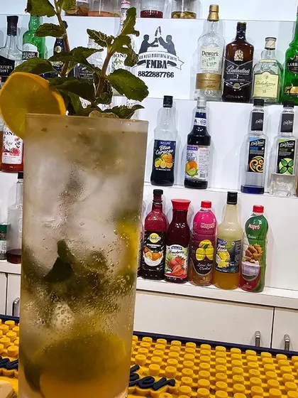 A tall and refreshing mocktail, packed with ice and fresh mint, ready to be served at our Goa branch.