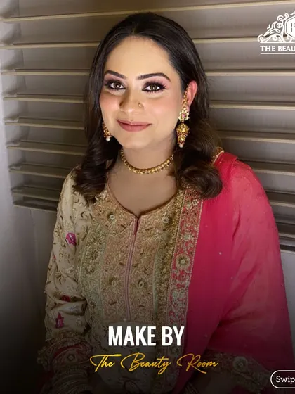 A lovely party makeup look for a client in a traditional suit. The makeup is polished and elegant, with a focus on defined eyes.