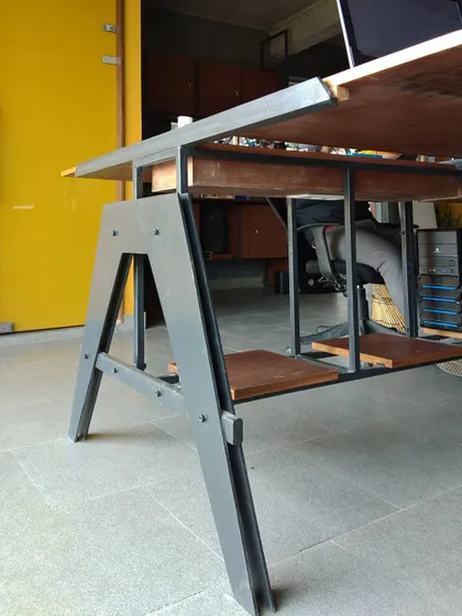 A custom steel workstation designed for our own studio in Ghitorni. The A-frame leg structure provides stability while maintaining a lightweight appearance, and the integrated plywood shelf adds a layer of practical storage.