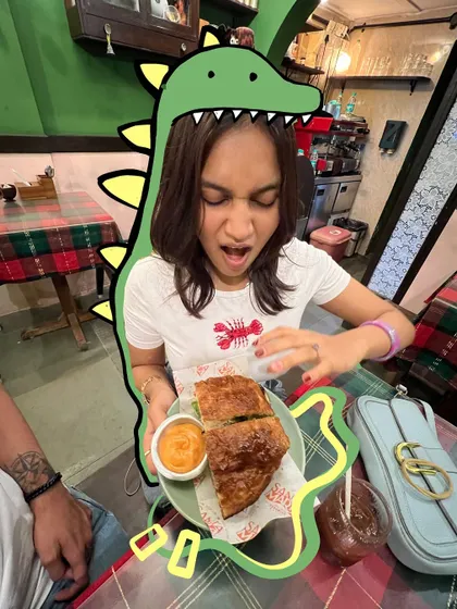 The only way to eat a sandwich. I added a goofy dinosaur doodle around my head to show my excitement.