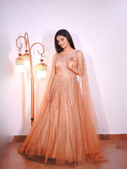 Another full-length shot of the golden gown, showing its flattering A-line cut.