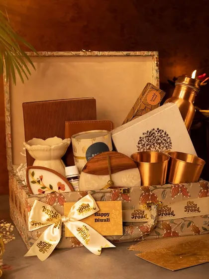 This eco-friendly Diwali hamper comes in a custom-printed box and includes items like a ceramic oil diffuser and copper tumblers, promoting a sustainable lifestyle.
