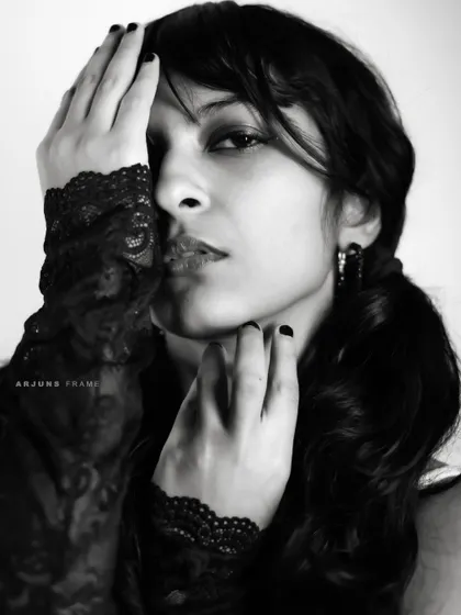 A close-up portrait from the 'Pretty in Punk' series. The focus on the lace gloves and intense gaze creates a dramatic and intimate feel within the punk aesthetic.