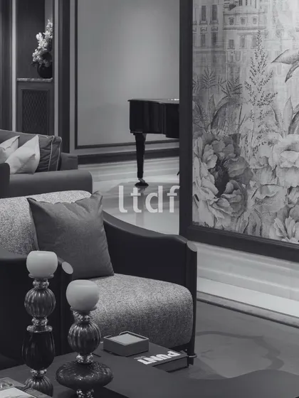 An atmosphere of understated elegance, where each detail from the plush seating to the exquisite floral wallpaper creates a serene and inviting living space. This room blends classic refinement with modern comfort, making it a perfect retreat within the home.