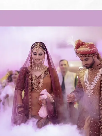 The couple makes their entrance, walking through a cloud of smoke, which adds a dreamy and dramatic effect to their wedding photos.
