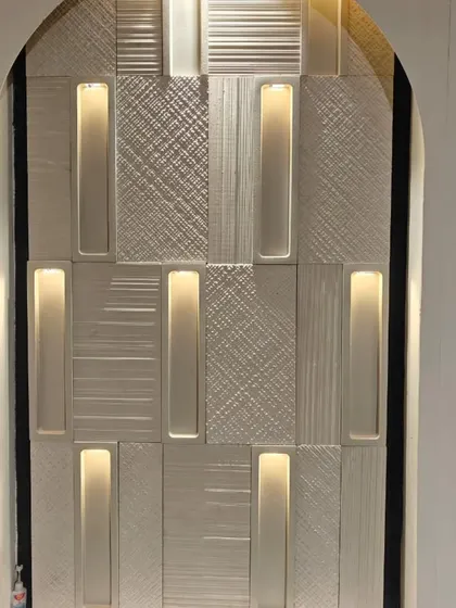 This stunning wall cladding combines textured panels with integrated, concealed lighting. The result is a sophisticated feature that provides both visual interest and ambient light.