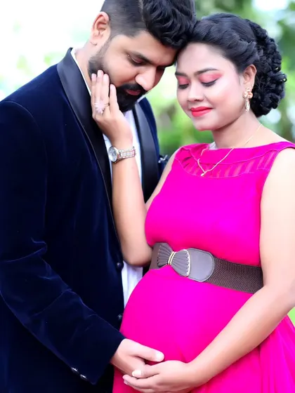 An intimate close-up of an expecting couple, highlighting their connection and the beautiful details of the pink maternity gown.