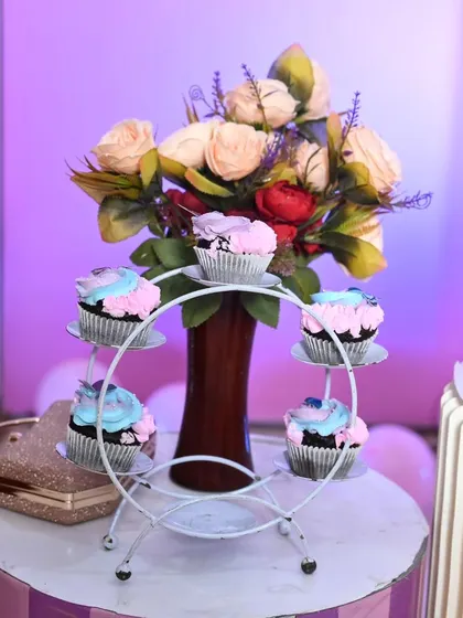 A cute cupcake stand adding to the butterfly theme's charm.