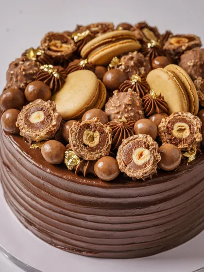 An overloaded chocolate and Ferrero Rocher cake. This shot is pure indulgence, designed to appeal to chocolate lovers and showcase a bakery's decadent offerings.