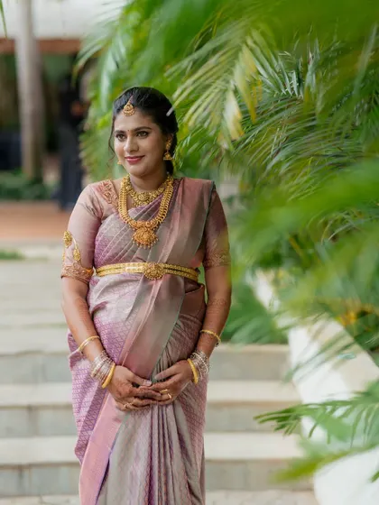 A lovely portrait of the mother-to-be at her traditional baby shower. The soft natural light and green palms create a serene backdrop for this milestone photograph.