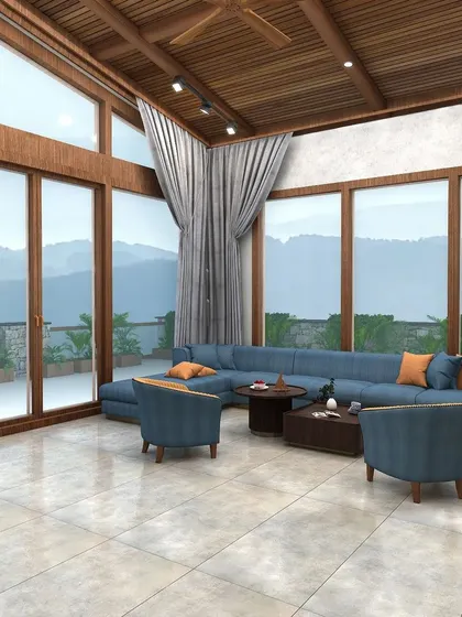 The full view of the lounge showcases the double-height windows and full-length curtains that frame the stunning natural scenery outside.
