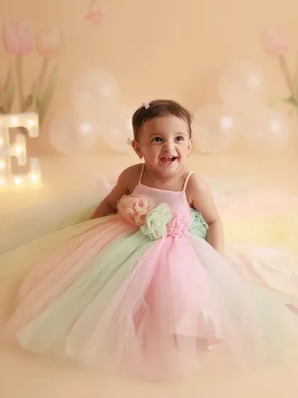 Happy First Birthday to this little ray of sunshine. Her joyful laugh and the pastel rainbow dress make this a perfect cake smash alternative for a one-year-old's photoshoot.
