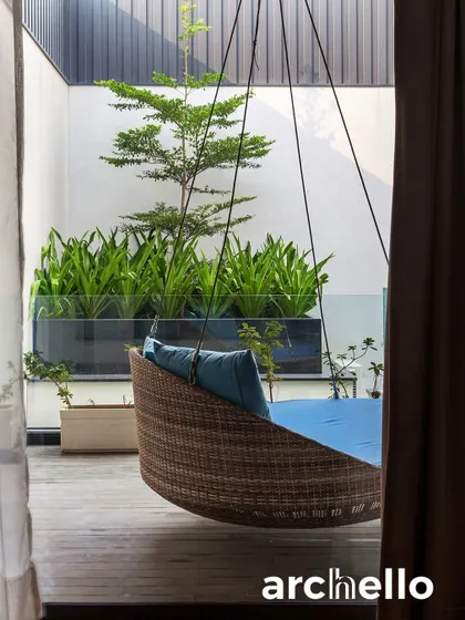 A cozy hanging swing on a private balcony, as featured in Archello. This small detail creates a perfect nook for reading or relaxing, demonstrating our belief that luxury is also found in quiet, personal moments.