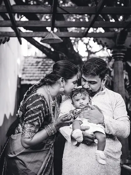 A quiet, intimate black and white photo of a family admiring their newborn. These are the moments that become the most treasured memories.