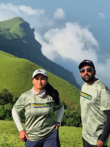 Two of our trek leads in our official gear, posing against the stunning backdrop of the Bandaje hills.