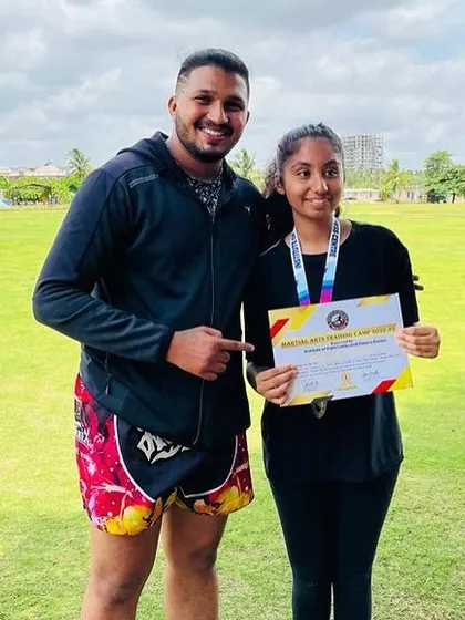 Another proud student displaying her certificate of achievement. Seeing my fighters succeed is my greatest reward as a coach.