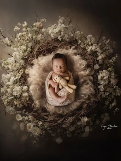 Nestled in a bed of soft white flowers, this little one is peacefully dreaming. My studio sessions use beautiful props and textures to create artistic, magazine-style portraits of your baby.