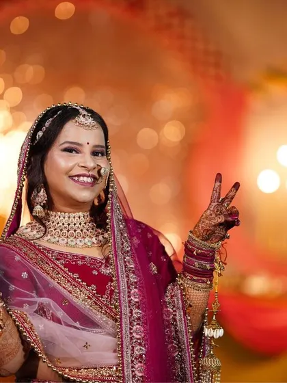 A happy bride flashing a peace sign. We love it when a bride's fun personality shines through in her portraits.
