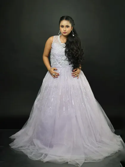 A classic pose in the lavender rental gown. The sleeveless design is perfect for warmer weather or indoor events.