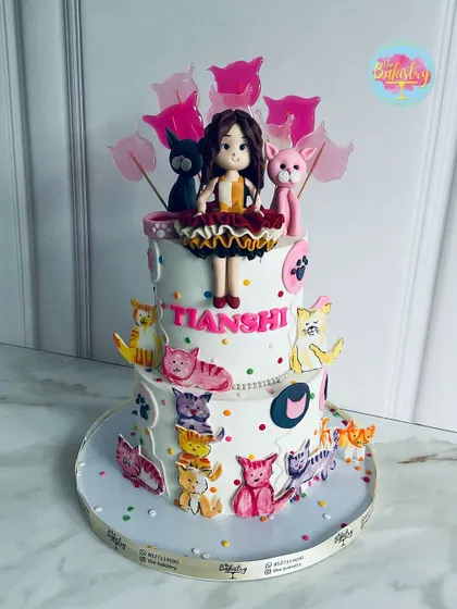 A custom two-tiered cake for Tianshi, covered in an array of colorful and playful cat figures.