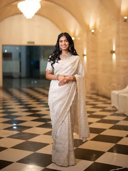 A stunning reception look. This bride chose an elegant white saree, and I created a classic soft glam look with voluminous waves.