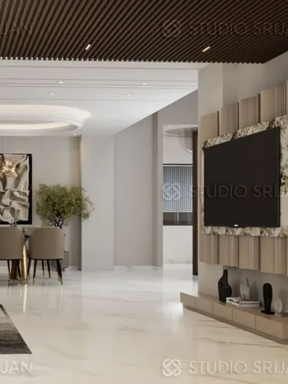 A view across the Krishna Park space, showing the flow from the dining area to the TV lounge, unified by a polished marble floor.