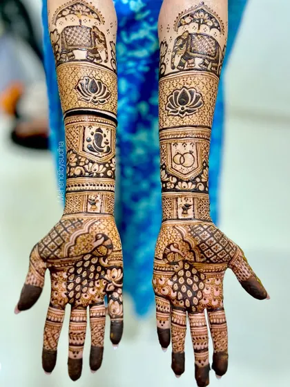 A beautiful engagement design incorporating auspicious symbols like Lord Ganesha and the lotus, alongside elephant motifs and the classic symbol of two rings.