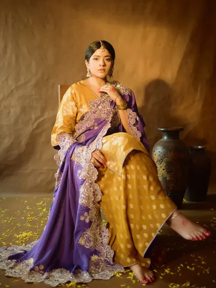 A full-length portrait that captures the complete royal look. The makeup is balanced to complement the rich fabrics and intricate embroidery of the outfit.