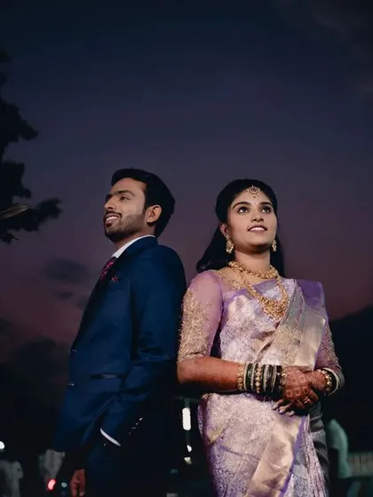 A creative twilight portrait of a couple. The beautiful colors of the sunset sky create a romantic and dramatic backdrop for this reception shot.
