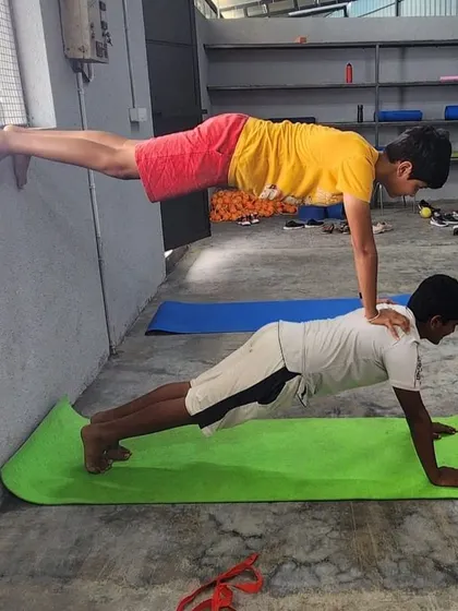 This wall-assisted double plank is a great example of the progressive exercises we use to build strength safely.