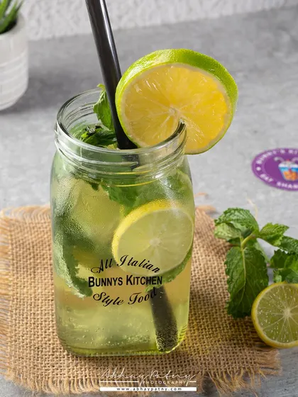 A classic Virgin Mojito. The shot is bright and clean, focusing on the fresh mint and lime to convey its refreshing quality.