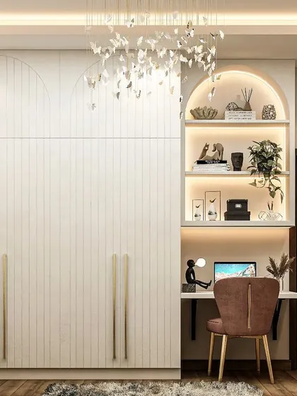 A clever design that integrates a study desk into a full-height wardrobe. The arched niche with built-in lighting provides a cozy and functional workspace without sacrificing storage.