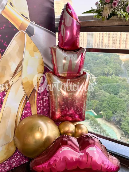 A fun and flirty collection of makeup-themed foil balloons, including lipstick and lips, perfect for a bachelorette or glam-themed party.