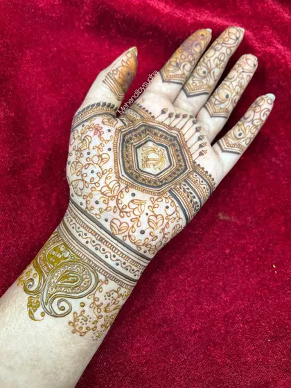 The completed minimalist design, with the hexagonal center surrounded by delicate heart-shaped vines and a simple paisley cuff.