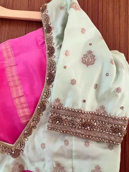 A close-up of the mint green blouse, showing the detailed zardosi and pearl embroidery along the V-neckline and sleeves.