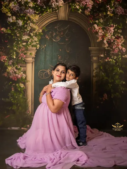 A sweet hug from behind! The older brother wraps his arms around his mom, a beautiful portrait of their bond before the new baby arrives.