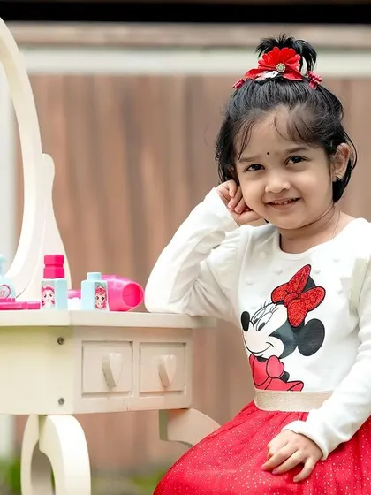 A little Minnie Mouse fan at her vanity table. We can incorporate your child's favorite characters into their photoshoot.