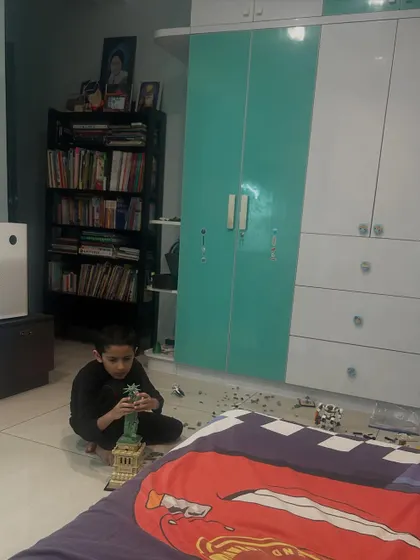 My son Kai rebuilding a complex Lego model of the Statue of Liberty after it broke. This moment captures important life skills like perseverance, focus, and the value of hard work.