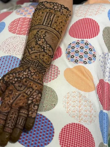 A full-arm design with a focus on traditional Indian patterns, perfect for a bride or for festive occasions.