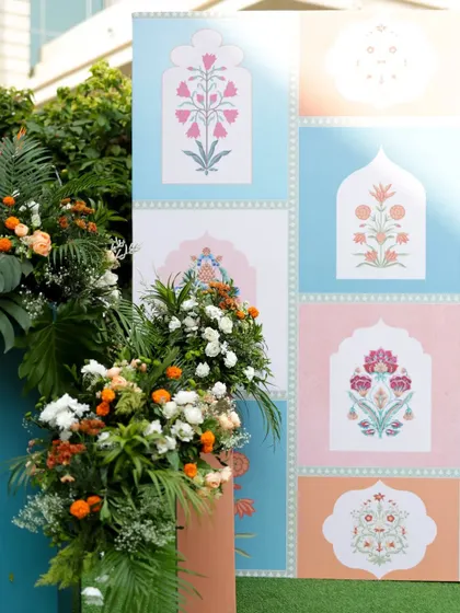 A detail shot of a pastel-themed backdrop, showing the beautiful Mughal-inspired floral block print designs used in the decor.