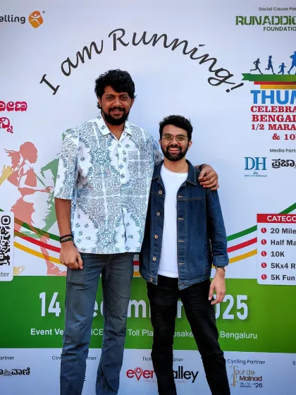 We take a picture beside the running-event backdrop after playing for the RunAddicts gathering in Bengaluru.