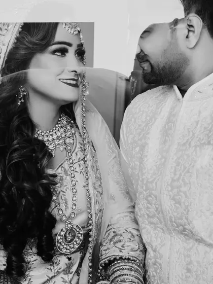 A beautiful black and white portrait of the couple sharing a laugh, with a creative reflection effect adding an artistic touch.
