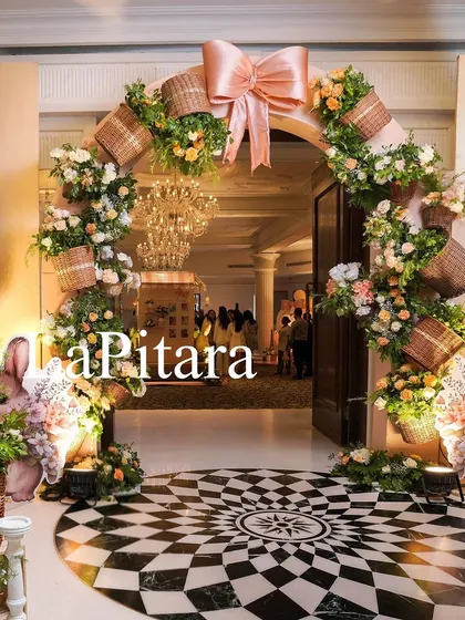 A stunning view of the main entrance arch, with its checkered floor and beautiful floral arrangements, creating a grand and welcoming impression.