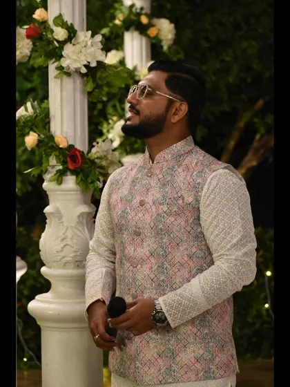 A candid moment, looking off-stage, always aware of the event's flow.