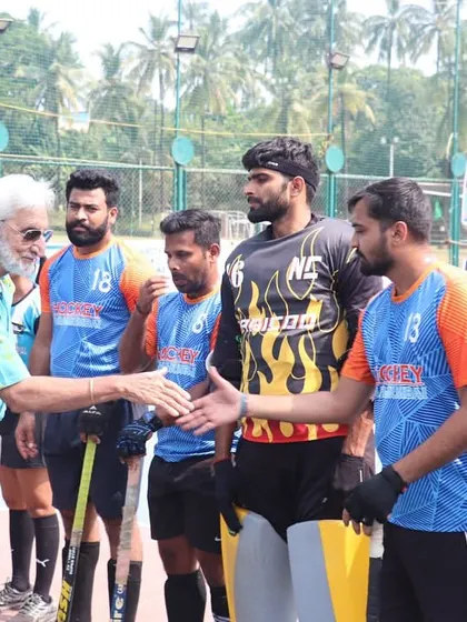 A moment of sportsmanship as our players shake hands with an official before a tournament match. We instill values of respect and integrity in all our athletes.