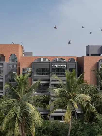 Aerial views of the ARCUS apartments in Chennai, showing how the building's form navigates the dense tree cover, creating a private oasis in the bustling T Nagar neighborhood.