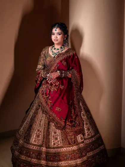 Another stunning portrait of Lavanya. The dramatic lighting highlights the rich textures of her outfit and the flawless finish of her makeup.