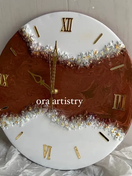 A classic geode-style clock with rich brown and white resin, accented with clear and gold crystals.
