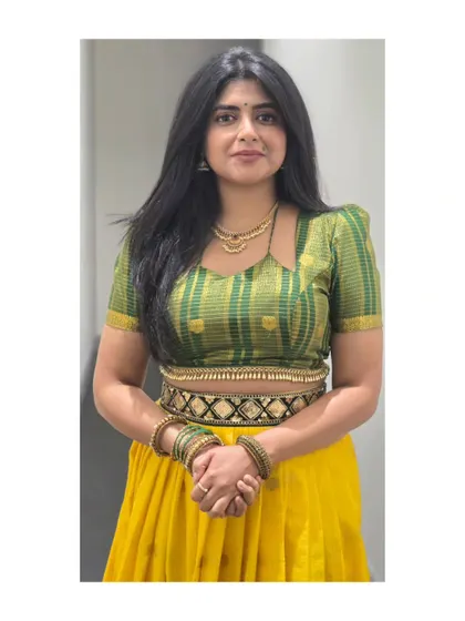 A full shot of the yellow and green lehenga, a vibrant choice for any celebration.